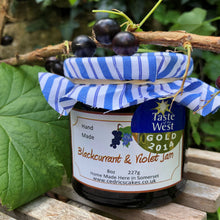 Load image into Gallery viewer, Blackcurrant and Violet Jam. Our ‘Taste of the West’ 2014 Gold Award Winning Jam. A rich, fragrant jam made from Ripe Blackcurrants combined with the beautiful taste of violets makes an extra special jam. Serving Suggestion: Try me nestled in the middle of a cupcake, Divine! Made by Hand at Cedrics in Somerset, England in tiny batches.
