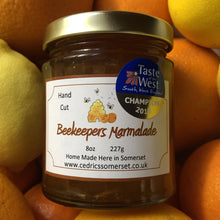 Load image into Gallery viewer, Champion Beekeepers Marmalade. Cedrics Champion Award Winning Beekeepers Marmalade. Made by Hand at Cedrics in Somerset, England in tiny batches.  Oranges and Somerset Honey.
