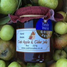 Load image into Gallery viewer, Crab apple and Cider Jelly. Our ‘Taste of the West’ 2013 Gold Award Winning Jelly.  A Somerset twist on a delicious rosy pink old favourite,  Serving Suggestion: Perfect partnered with cold pork and cheese!  Made by Hand at Cedrics in Somerset, England in tiny batches. 
