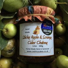 Load image into Gallery viewer, Sticky Apple and Scrumpy Cider Chutney. Our ‘Taste of the West’ 2017 Silver Award Winning Chutney. A smooth, mellow full-bodied chutney. Serving Suggestion: Perfect with Cold cuts and local cheeses. Try with a Ploughman&#39;s. Made by Hand at Cedrics in Somerset, England in tiny batches.
